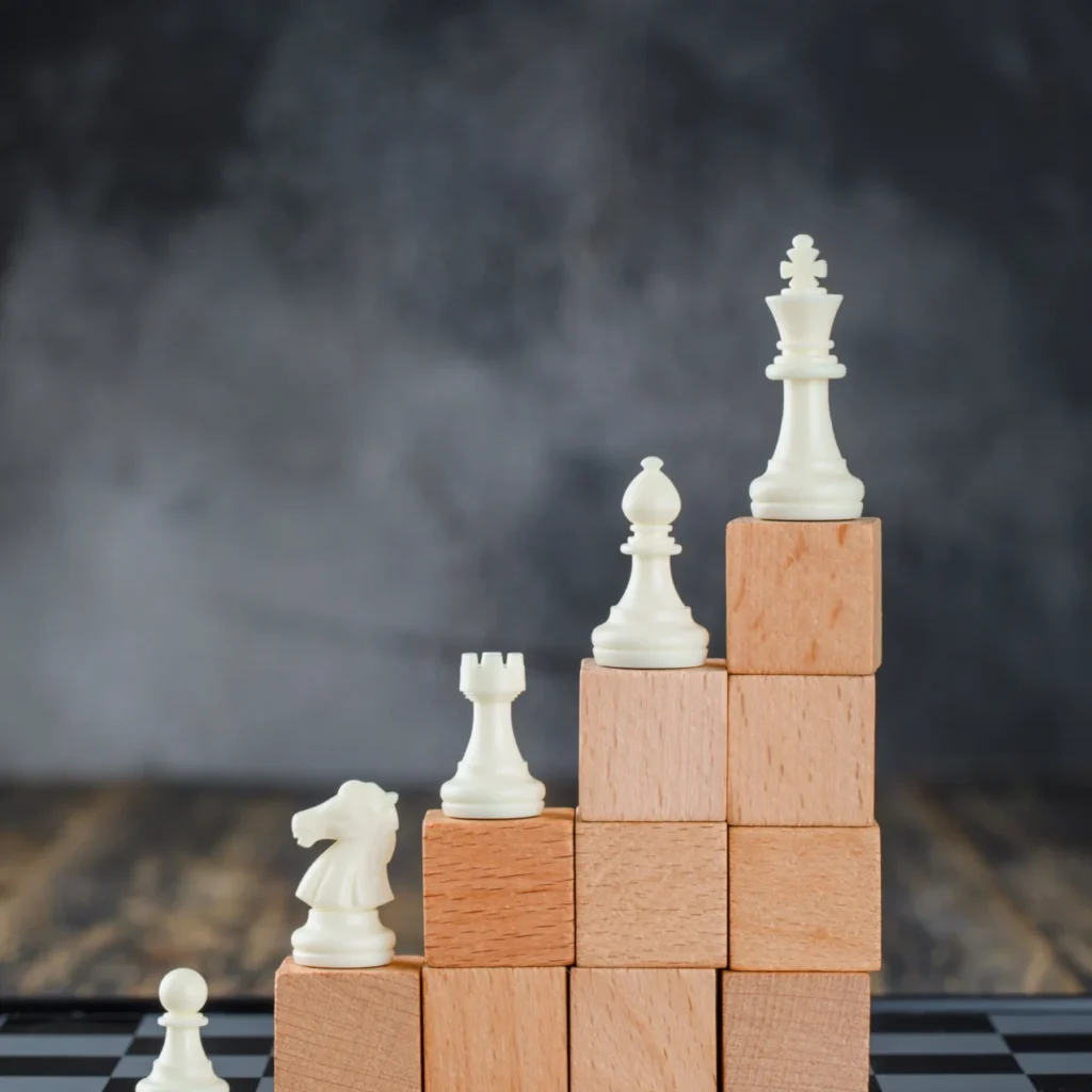 business-hierarchy-concept-with-chessboard-figures-pyramid-wooden-blocks-foggy-wooden-table-side-view-1276x1536